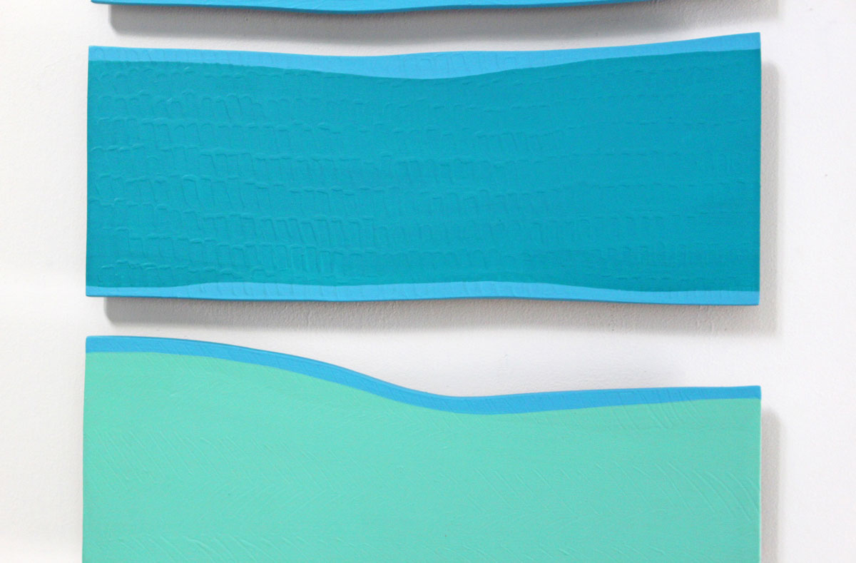 A detail image of an abstract artwork featuring overlapping panels of blue, green, and white colors on a white background.