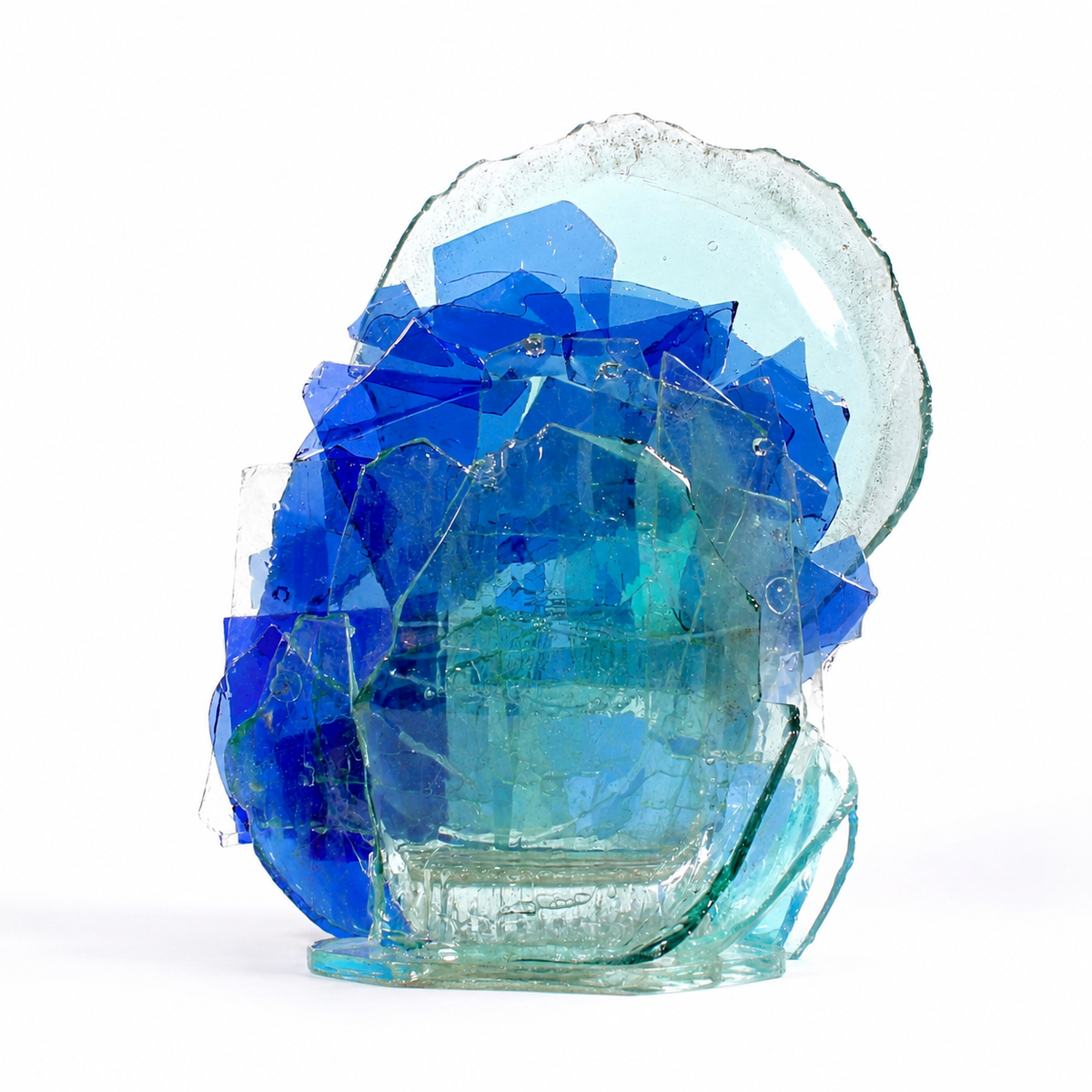 Glass sculpture with blue and clear geometric shapes on a white background