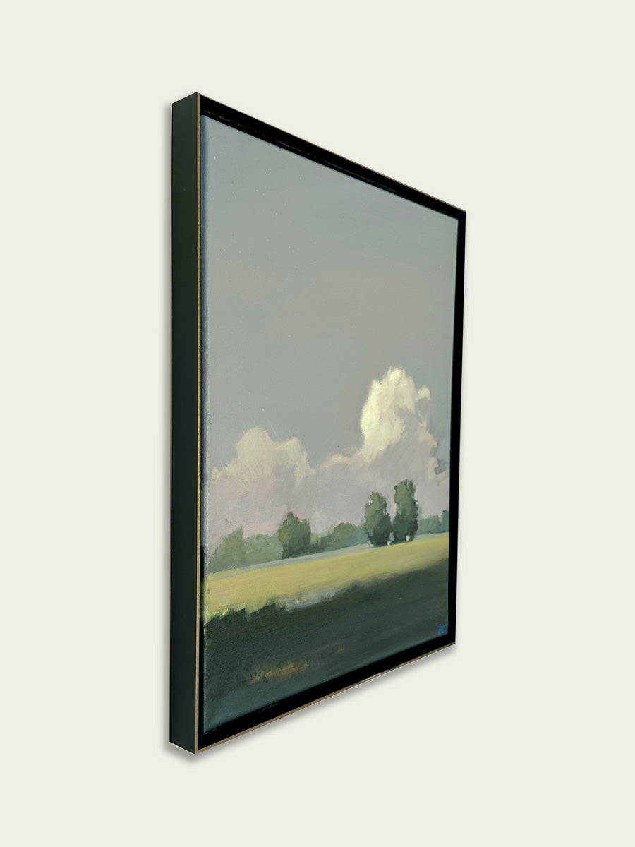 Framed artwork of a landscape with trees and clouds on a white background