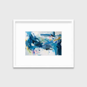 A blue and white abstract print by Kelly Rossetti in a white frame with a mat hangs on a white wall.
