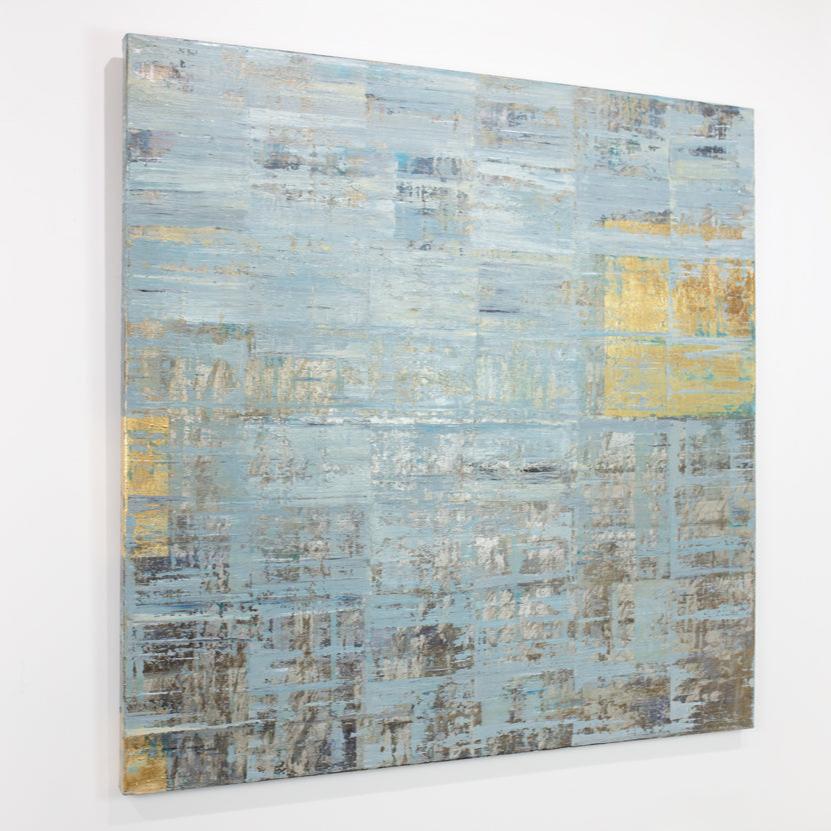 A blue and gold abstract painting hangs on a white wall.