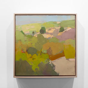 A green abstracted landscape painting framed in a wood floating frame hangs on a white wall.