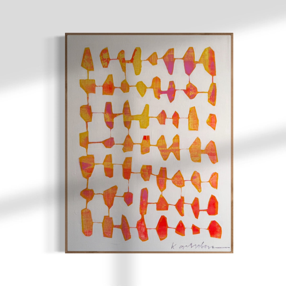 Framed abstract art with red and orange patterns on a white background.