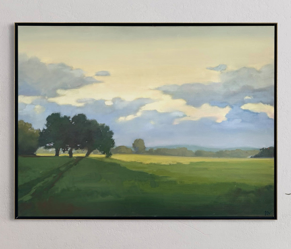 Framed painting of a landscape with trees and a sky.