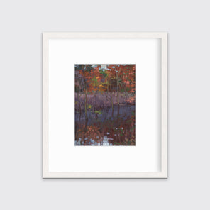 A muted multicolored abstract landscape print in a whitewashed frame with a mat hangs on a white wall.