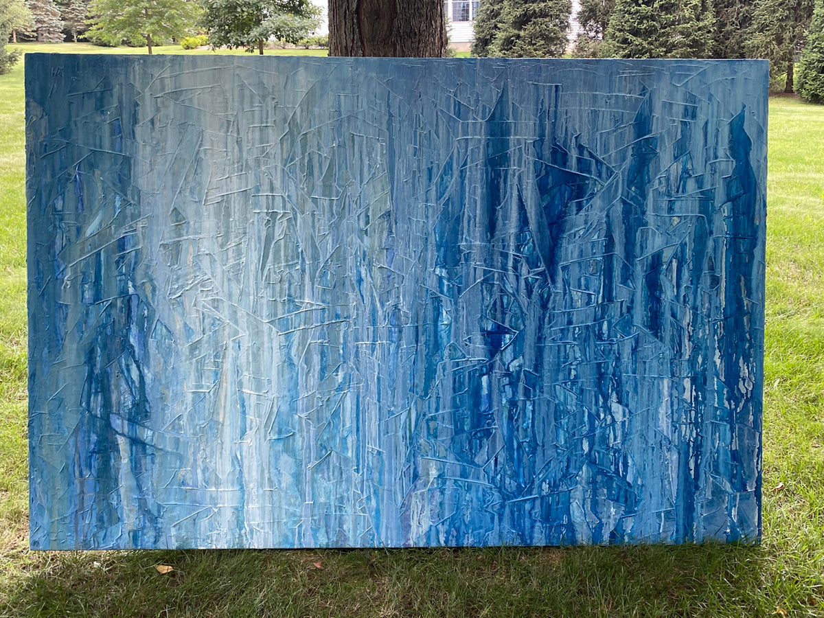 Abstract blue painting on a grassy background