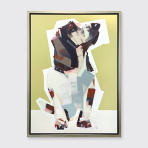 A chartreuse, navy, beige and light blue abstract dog print in a silver floater frame hangs on a white wall.