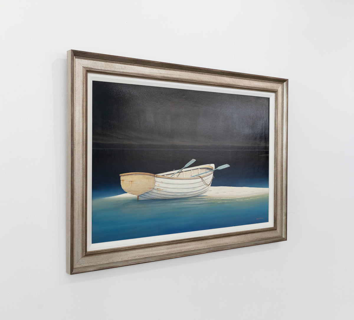 Painting of a rowboat stuck on a sandbank is seen at an angle on a gallery wall.