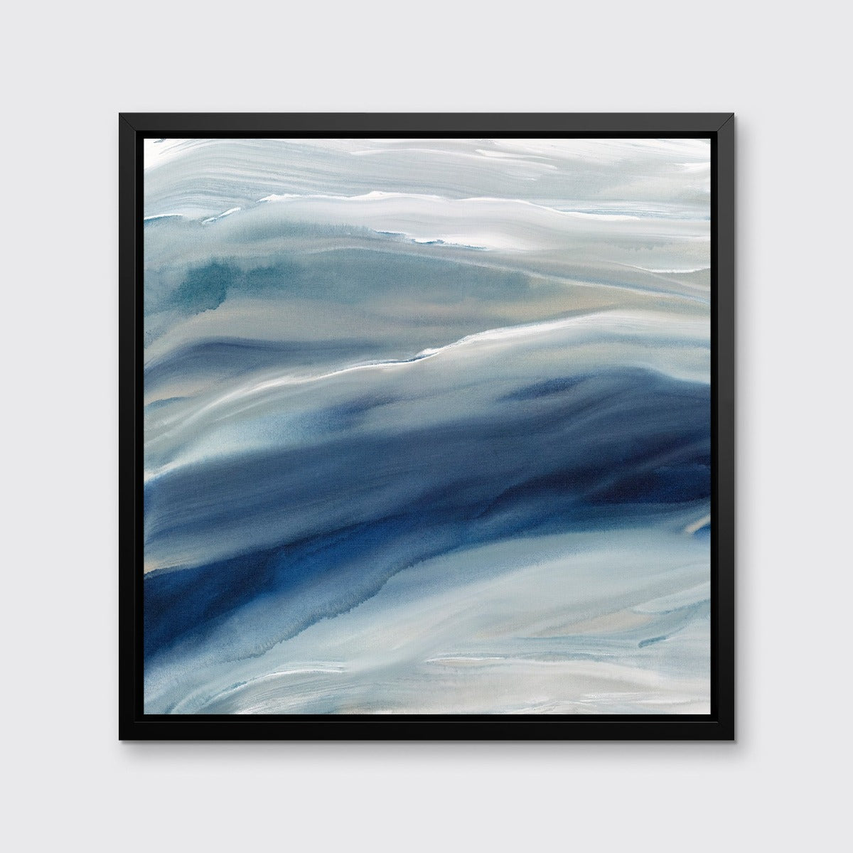 A blue, teal, beige and white abstract print in a black wood floater frame hangs on a white wall.