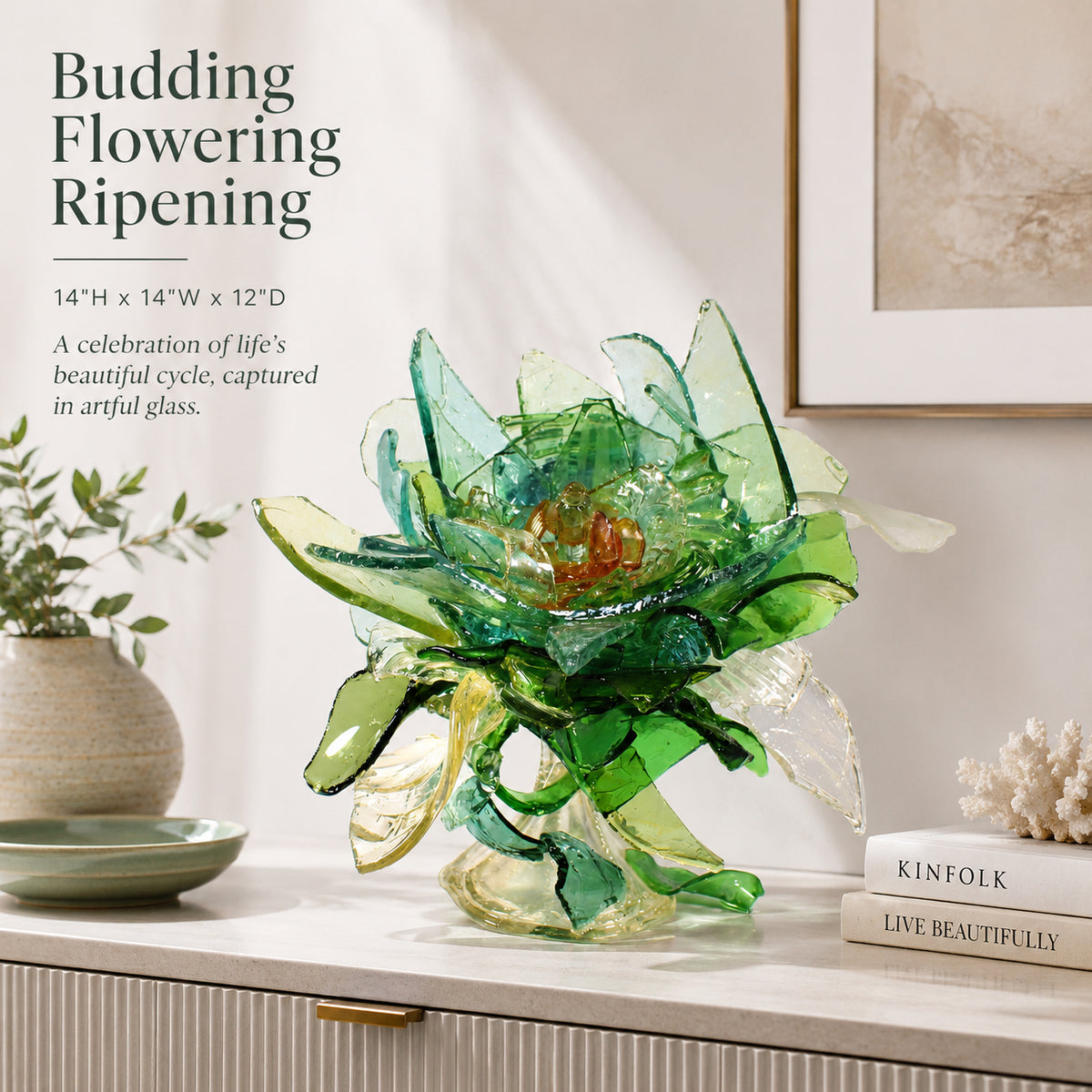 Artistic glass sculpture resembling a flower on a table with decor items and text about life's cycle.