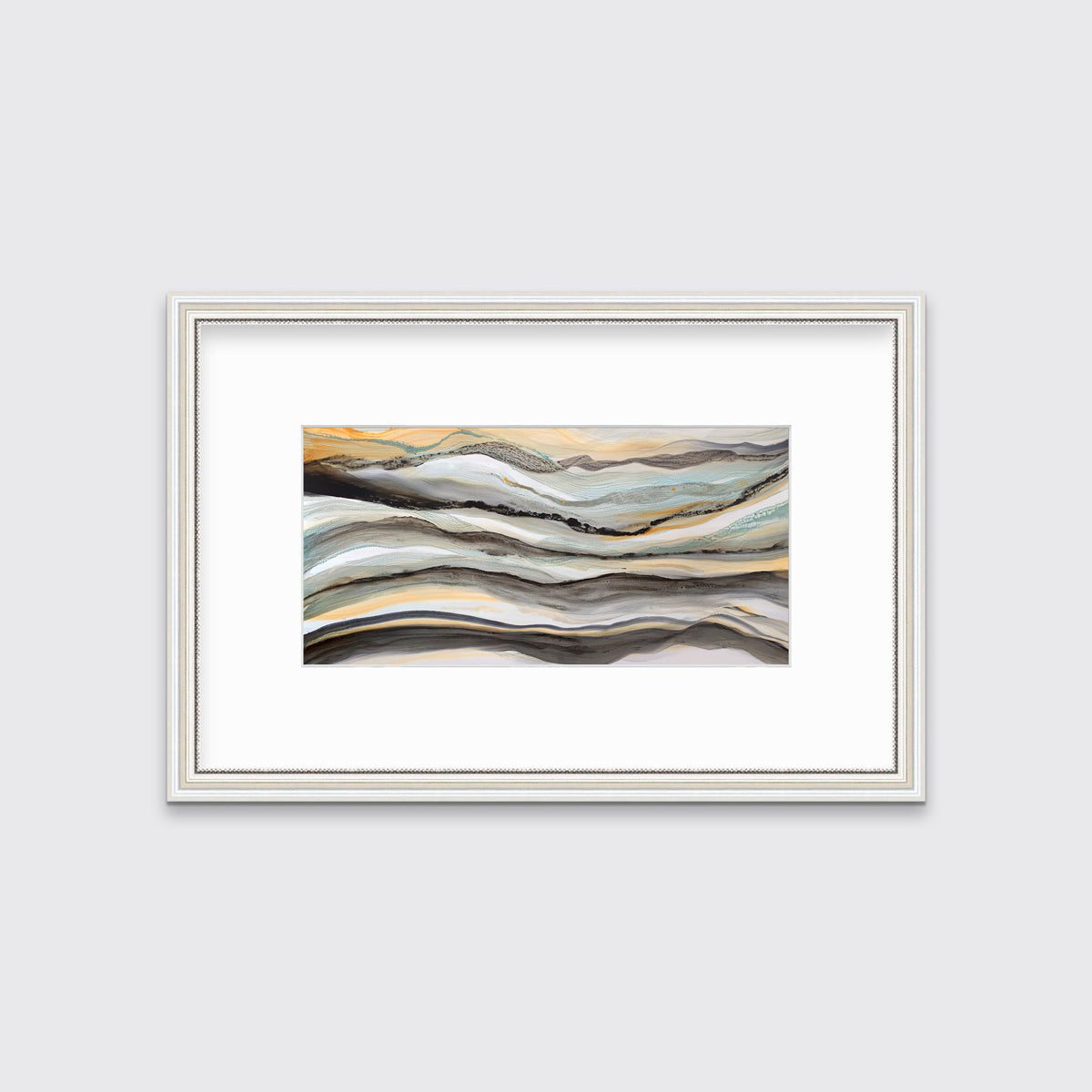 A black, white, orange and teal abstract print in a white frame with antiqued beading with a mat hangs on a white wall.