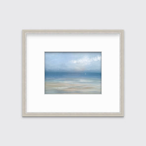 A light blue, white and beige abstract seascape print in a silver frame with a mat hangs on a white wall.