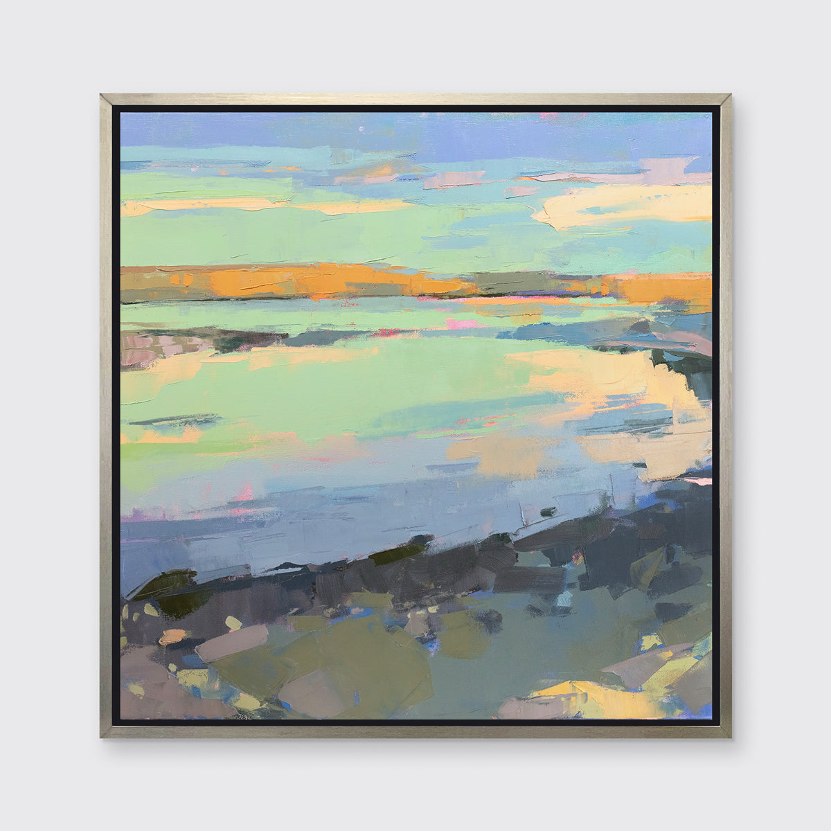 A colorful abstract landscape print framed in a silver frame hangs on a white wall.