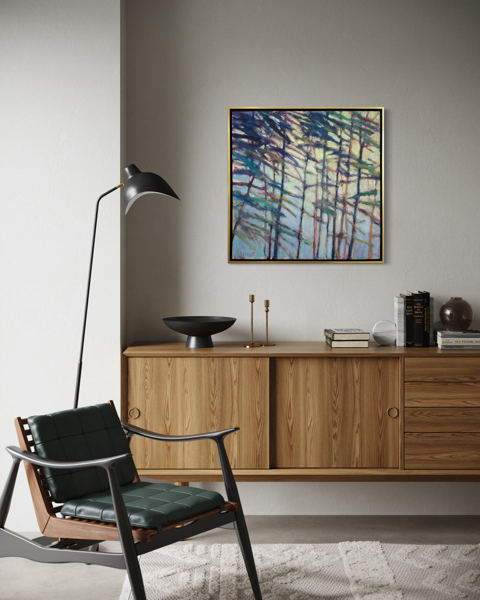 Modern living room with wooden cabinet, black chair, and abstract painting on gray wall.