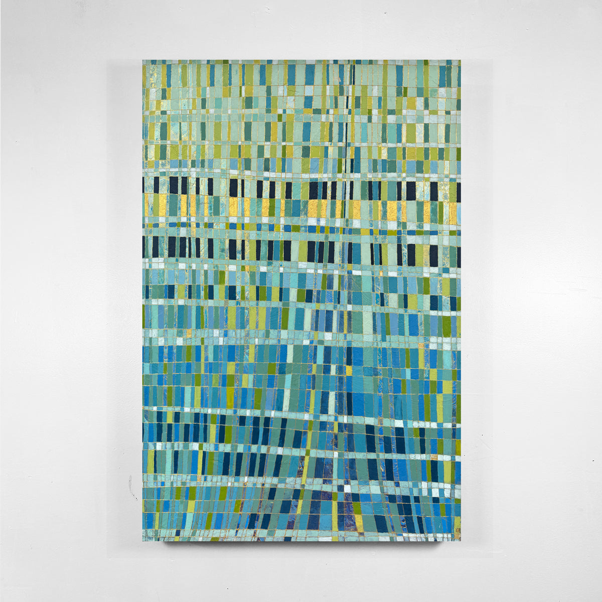 An abstract canvas painting featuring a textured mosaic pattern of blue, green, and yellow horizontal rectangles, displayed against a clean white wall.