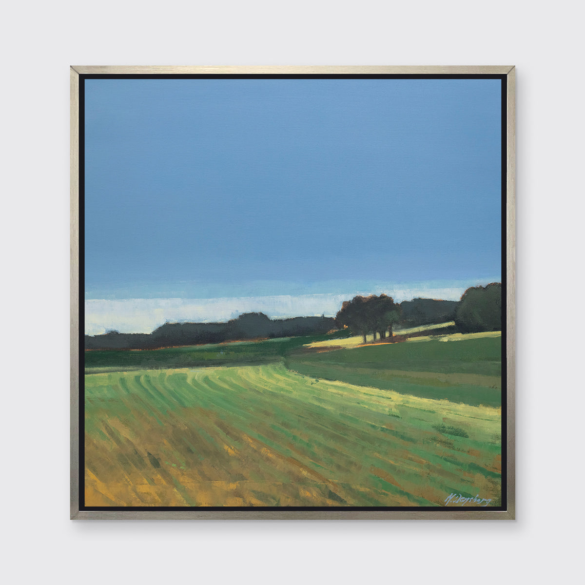 A landscape print in a silver floater frame hangs on a white wall.