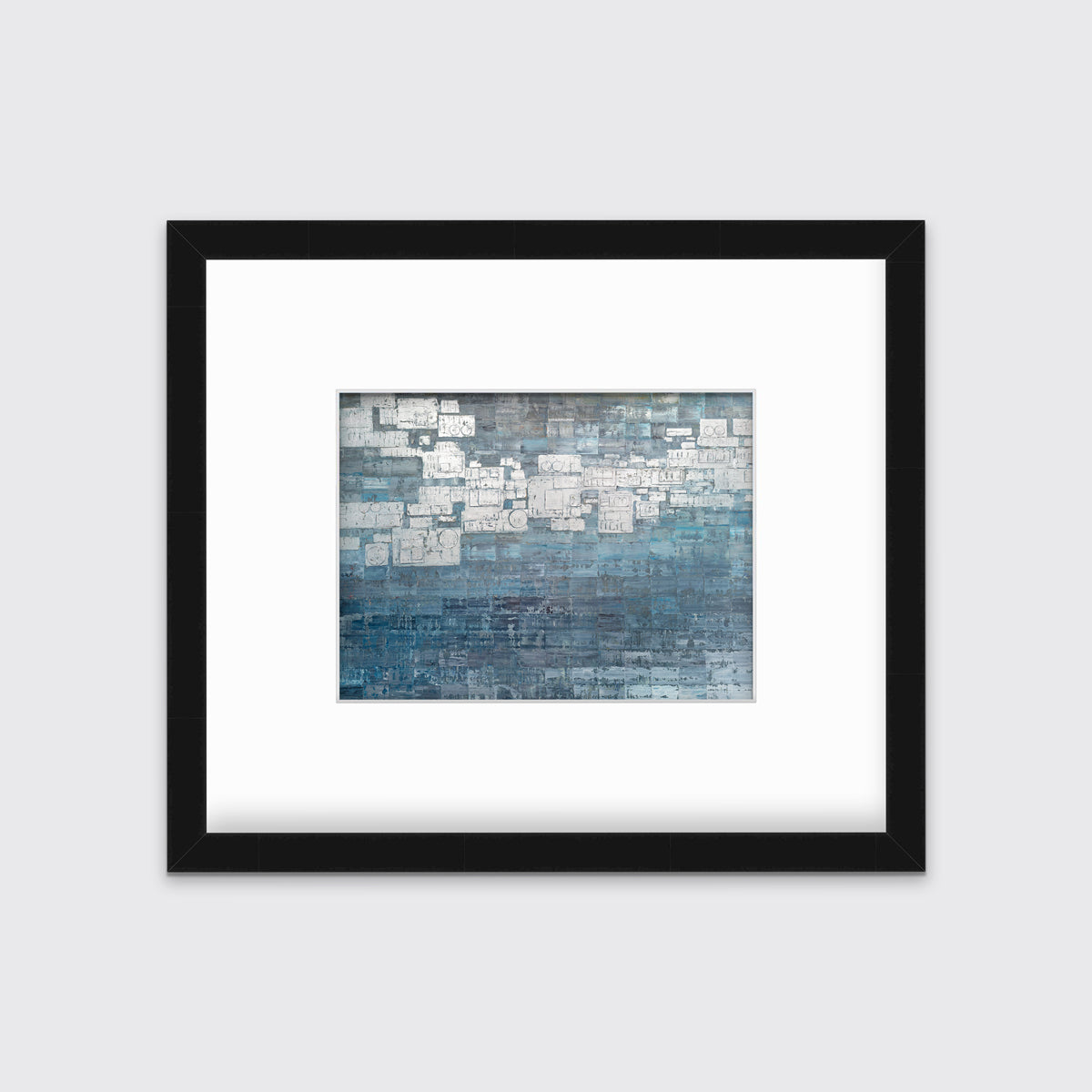 A blue, white and grey abstract print in a black frame with a mat hangs on a white wall.