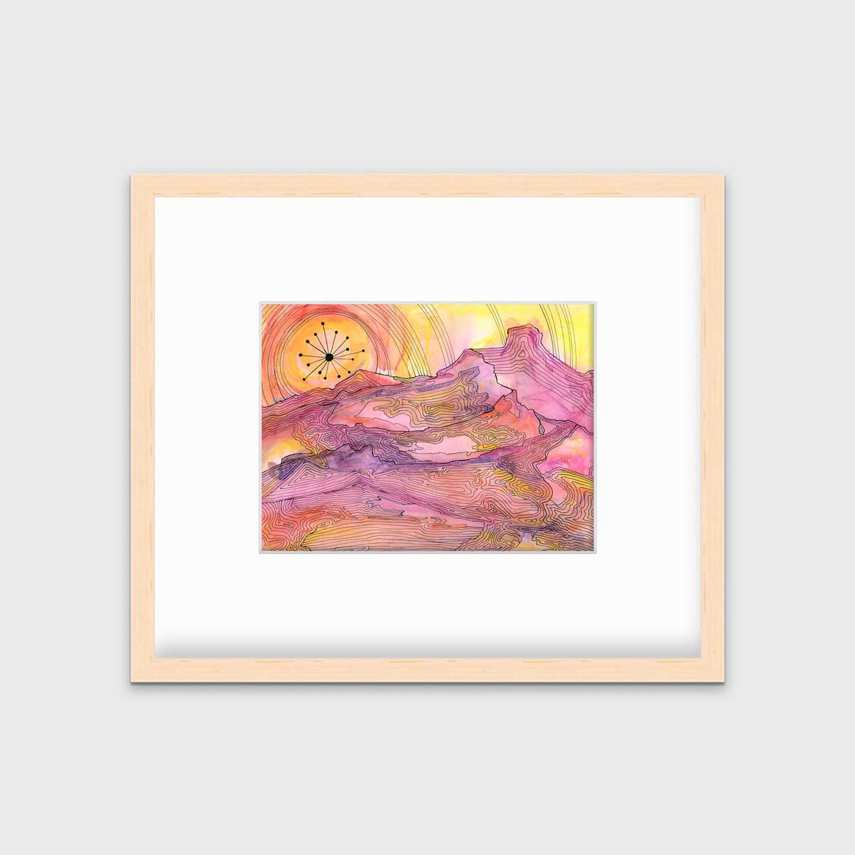 A pink, yellow and orange abstract landscape print with black outlines in a natural wood frame with a mat hangs on a white wall.
