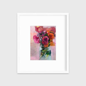 A pink, orange and green abstract floral print in a white frame with a mat hangs on a white wall.