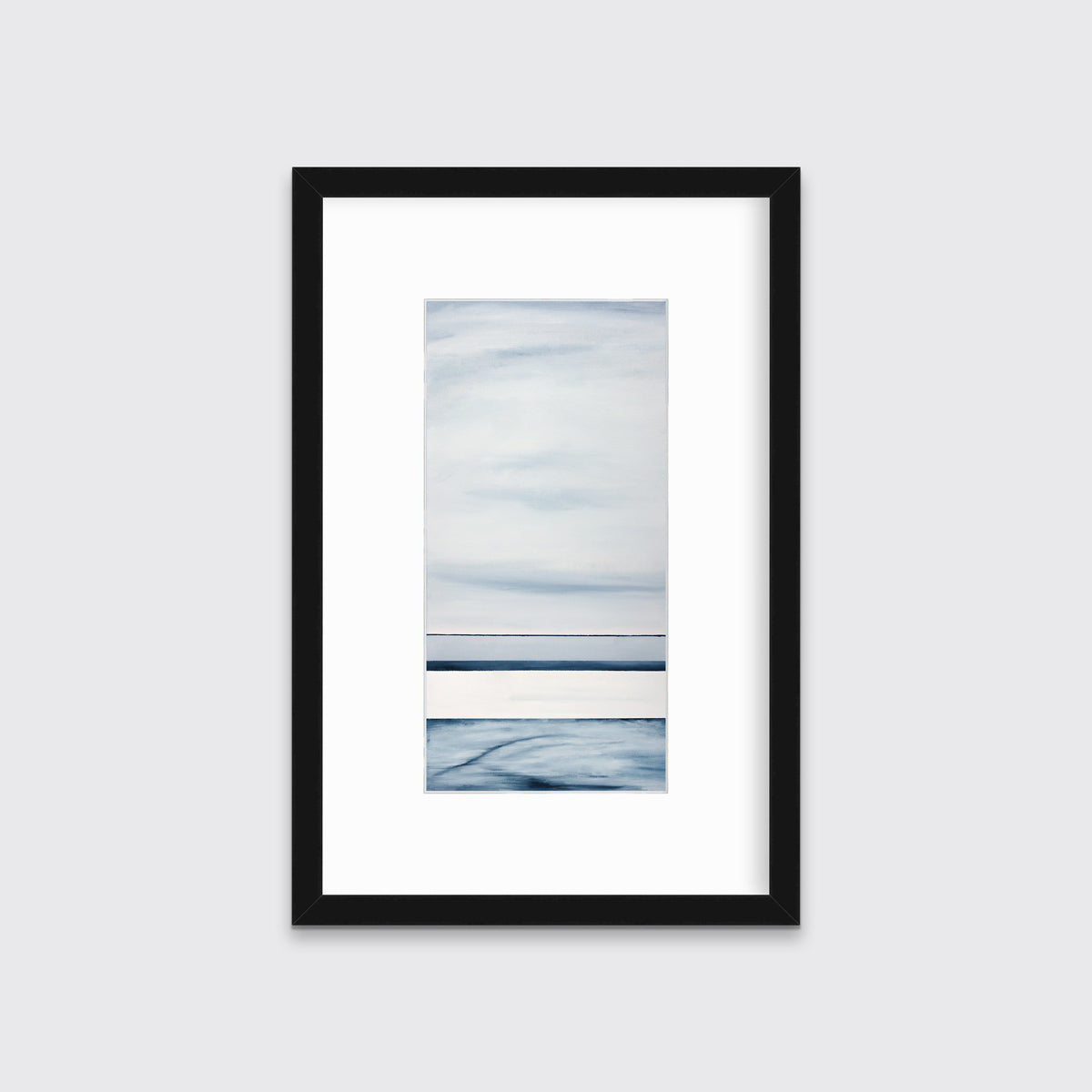 A blue-grey abstract print hangs in a black frame with a mat on a wall.