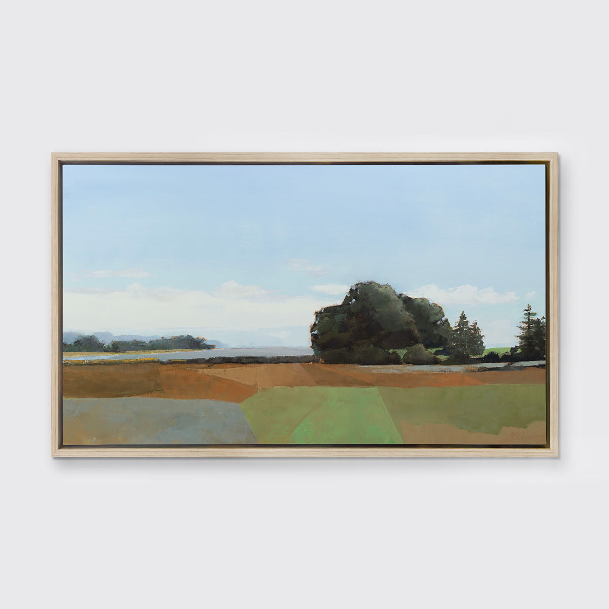 A landscape print in a white oak wood floater frame hangs on a white wall.