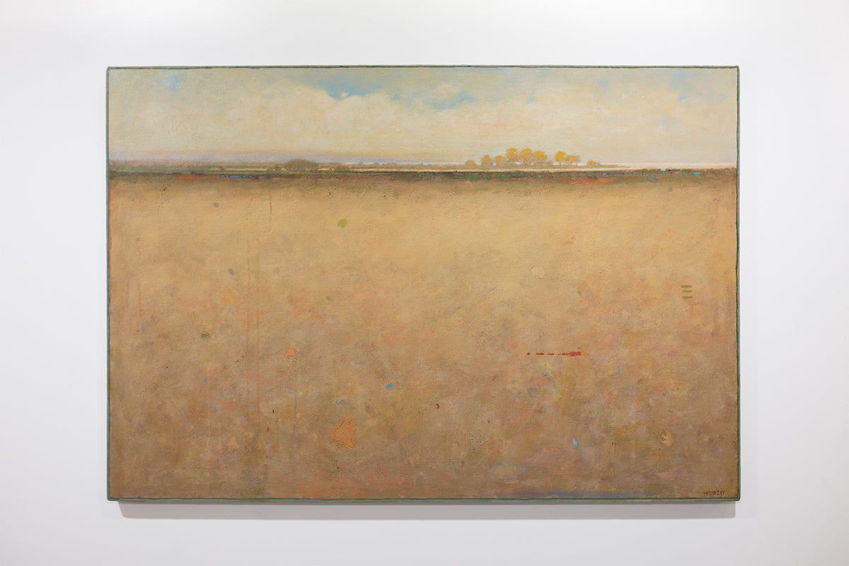 A beige and blue abstract landscape painting hangs on a white wall.
