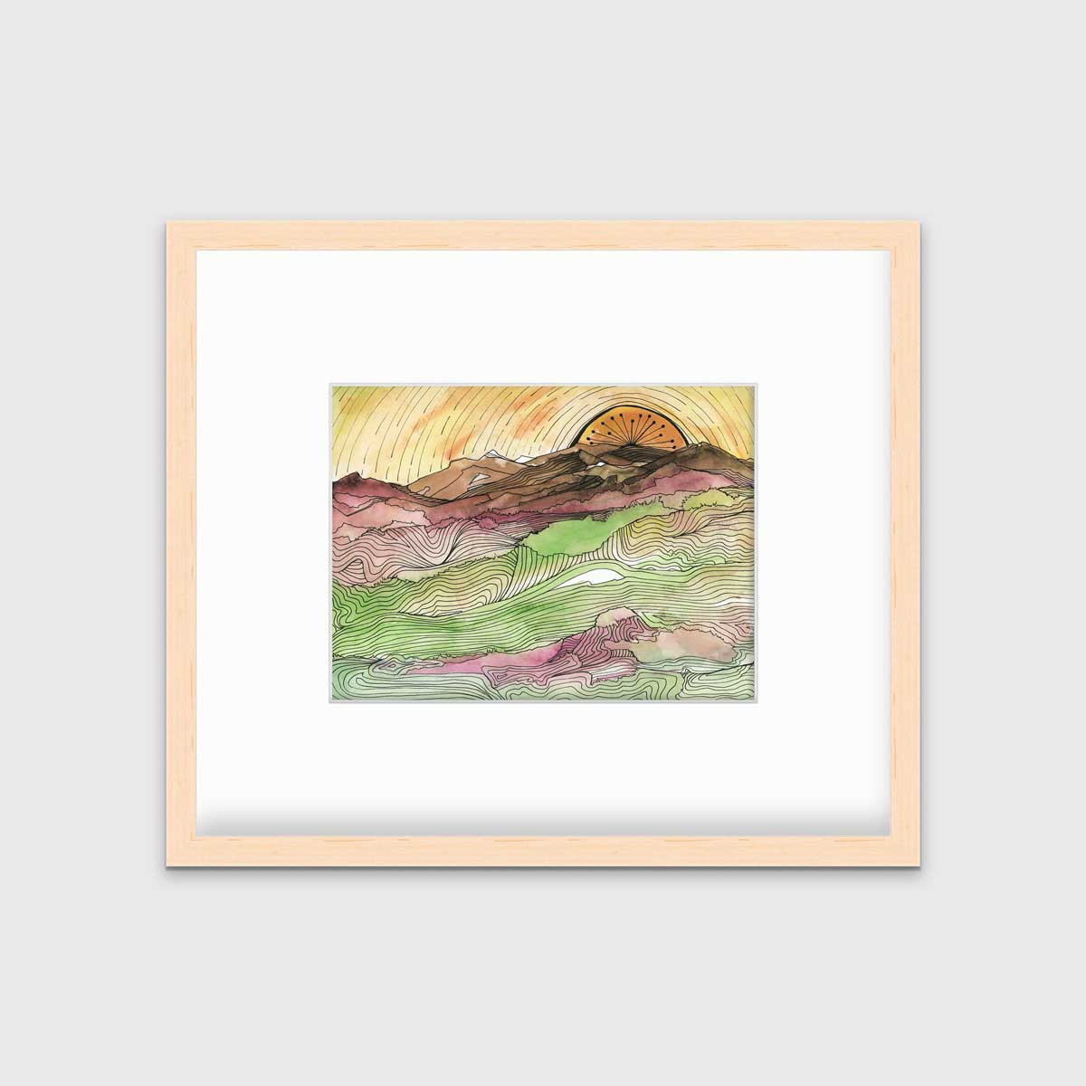 A yellow, brown, green and dark rose abstract landscape print with black outlines in a natural wood frame with a mat hangs on a white wall.