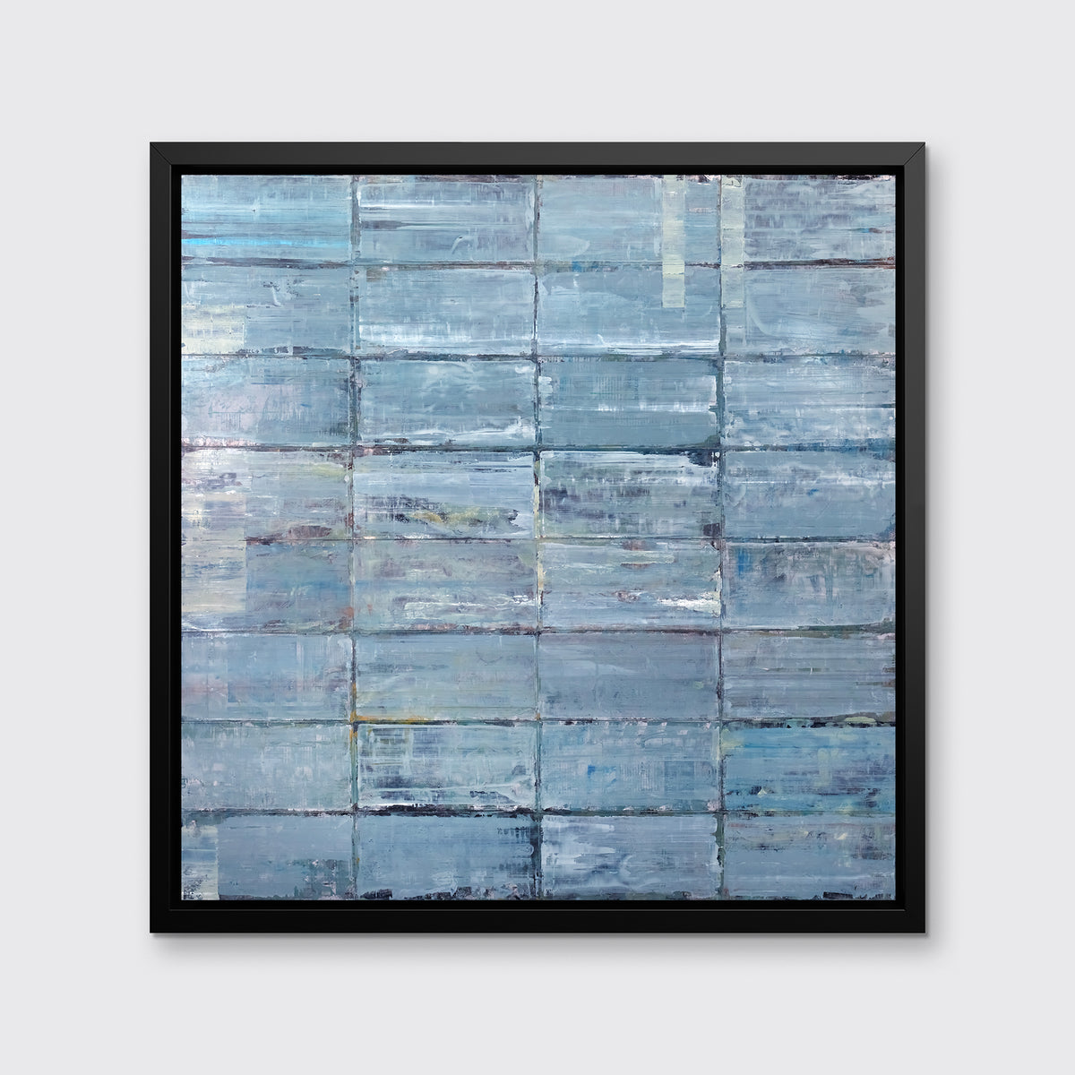 An abstract blue-green limited edition art print by Ned Martin in a black frame hangs on a white wall.