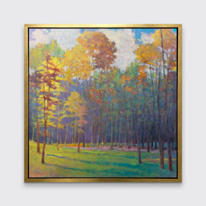 An impressionist landscape print in a gold floater frame hangs on a white wall.