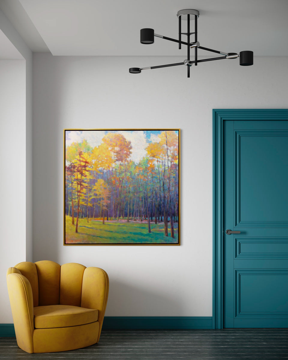 A colorful abstracted landscape painting hangs on a white wall between a teal door and a mustard yellow seashell shaped armchair.