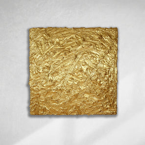 A metallic gold thick textured painting on a white wall in natural light by Teodora Guererra.