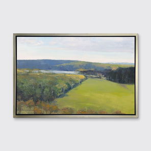 A landscape print in a silver floater frame hangs on a white wall.