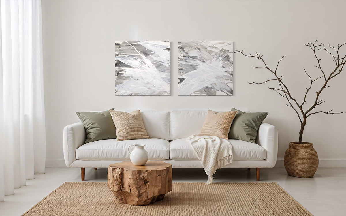 Modern living room with a white sofa, wooden coffee table, and original abstract painting.