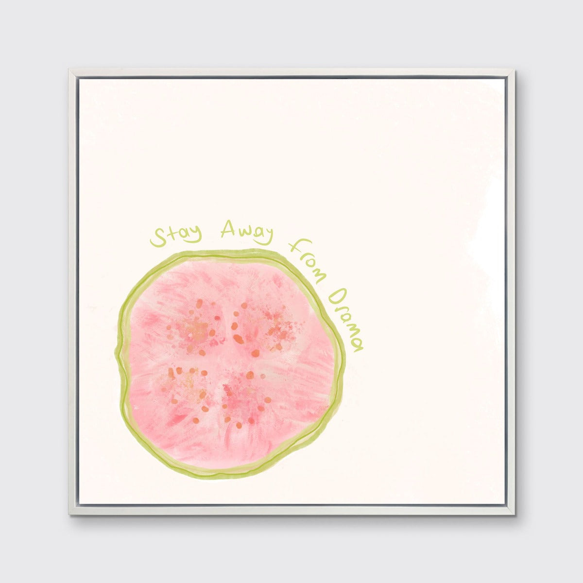 An abstract art print of a fruit framed in a white frame hangs on a light wall.