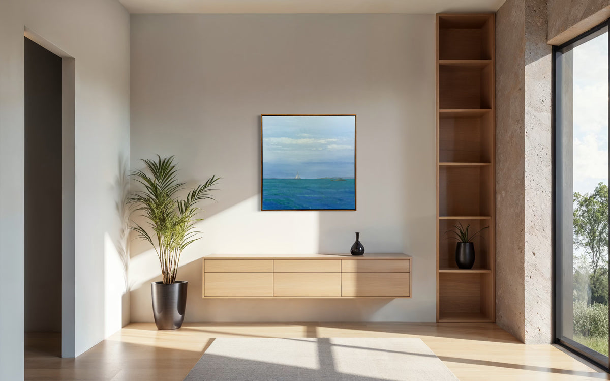 Modern living room with a painting on the wall, wooden cabinet, and plant.