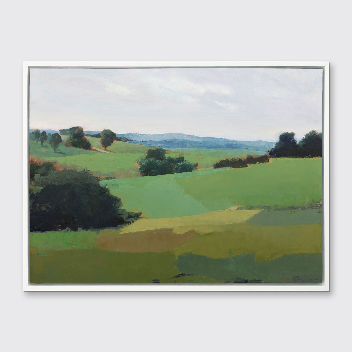A green limited edition landscape print in a white floater frame hangs on a white wall.