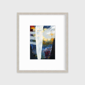 A white, yellow, red and grey abstract print in a silver frame with a mat hangs on a white wall.