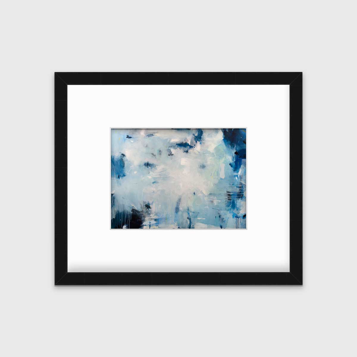 A blue and white abstract print by Kelly Rossetti in a black frame with a mat hangs on a white wall.
