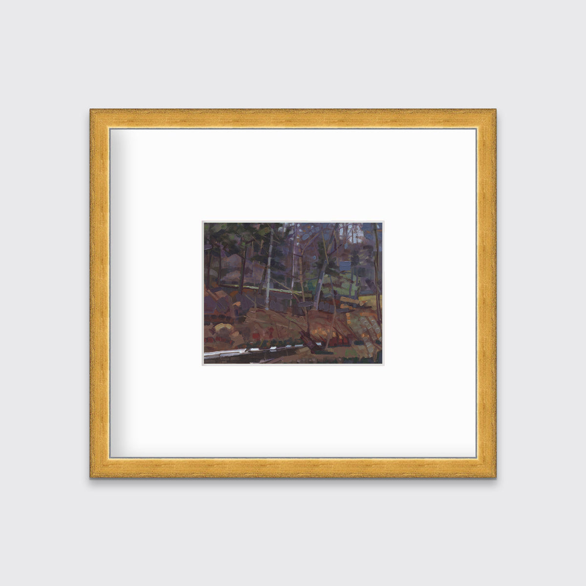 A brown, grey and green abstract landscape print in a gold frame with a mat hangs on a white wall.