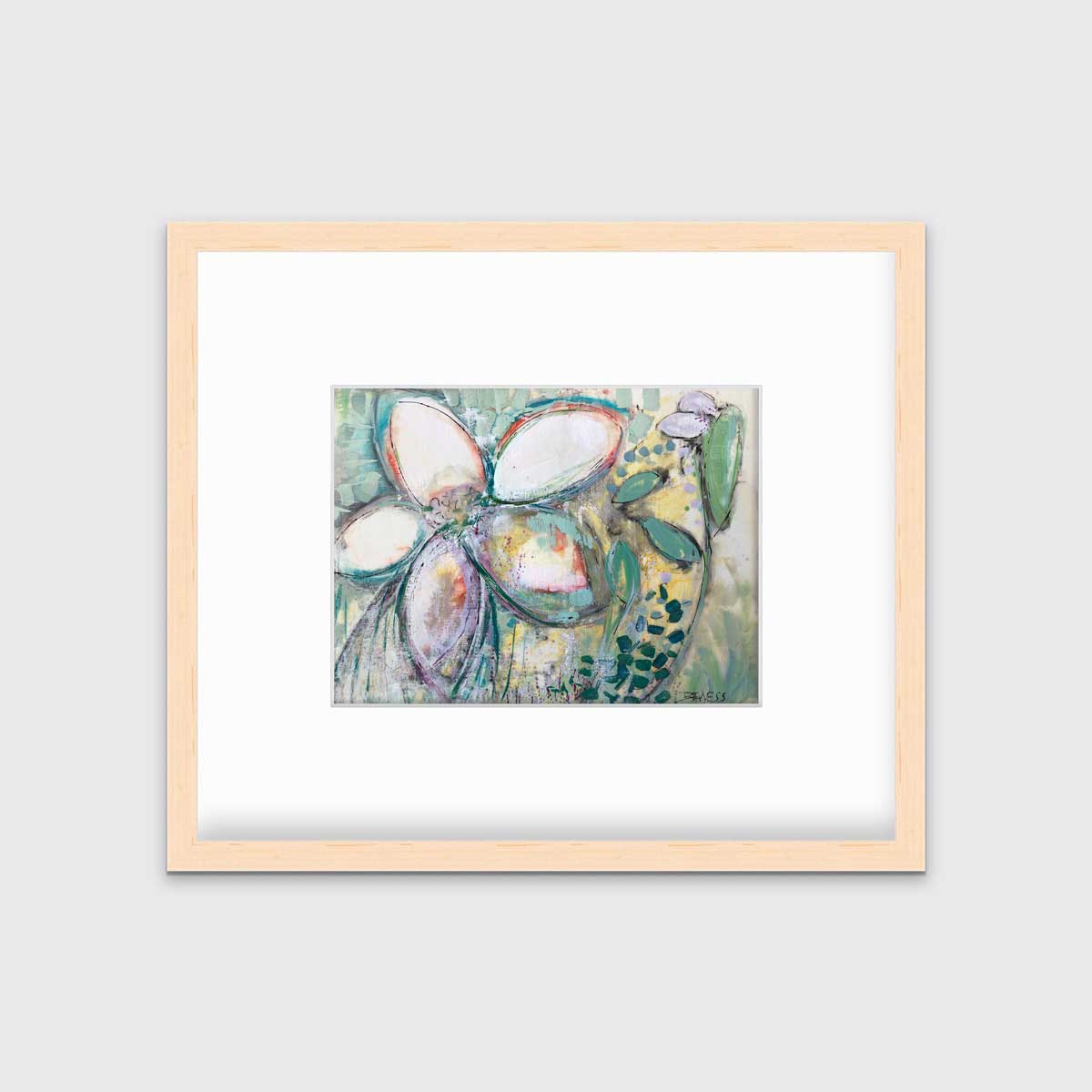 An abstract floral print in a natural wood frame with a mat hangs on a white wall.