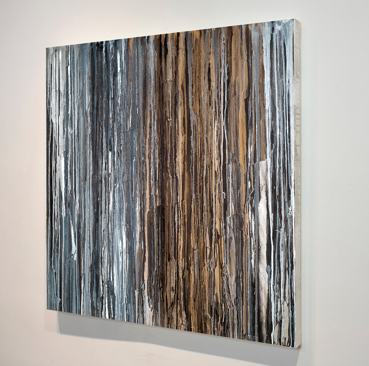 A 48" x 48" original abstract painting with beige, black, brown, gray, and white dripped oil paint, titled 'Just Add Shoes' by Teodora Guererra, side view.