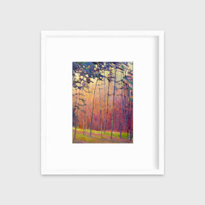 A red, orange and blue abstract tree landscape print in a white frame with a mat hangs on a white wall.