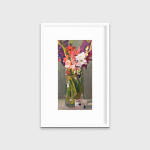 A purple, pink and green abstract floral print in a white frame with a mat hangs on a white wall.