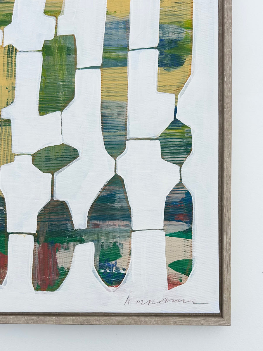 A detail of a signed abstract painting in a wood frame.
