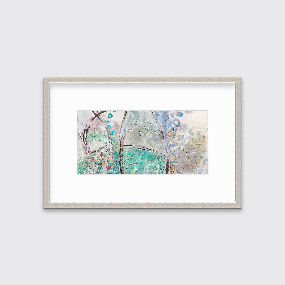A teal, beige and mauve abstract landscape print in a silver frame with a mat hangs on a white wall.