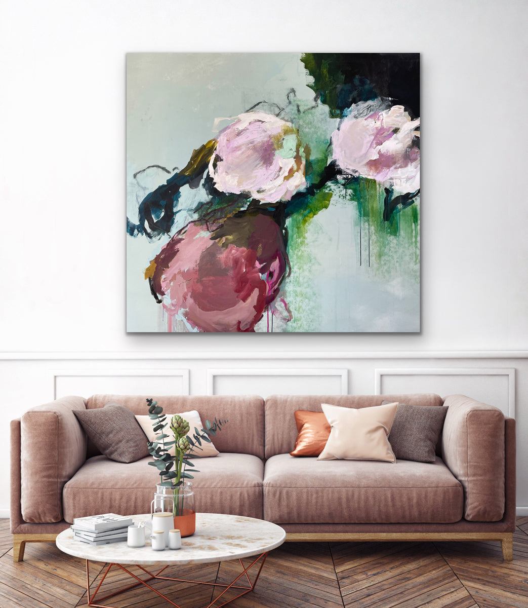 Abstract floral painting above a beige sofa in a living room.