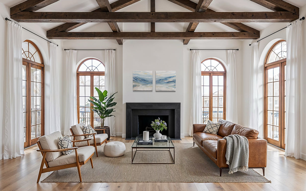 Living room with wooden beams, large windows, and diptych abstract paintings by Teo Guererra.