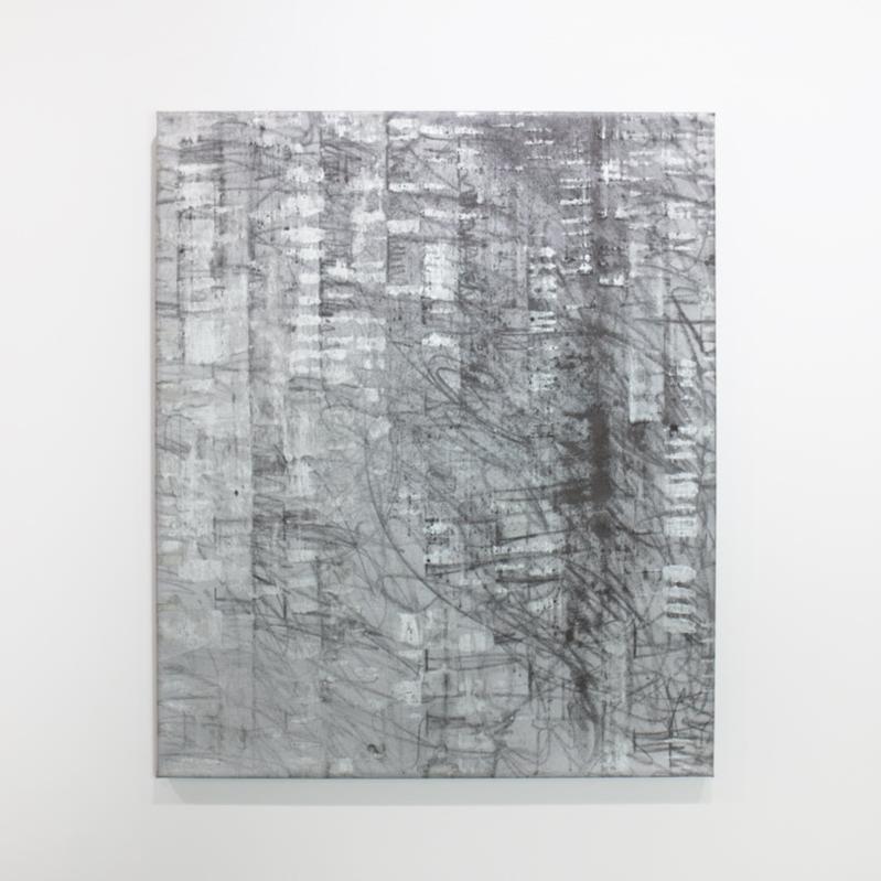 A black and silver abstract painting hangs on a white wall.