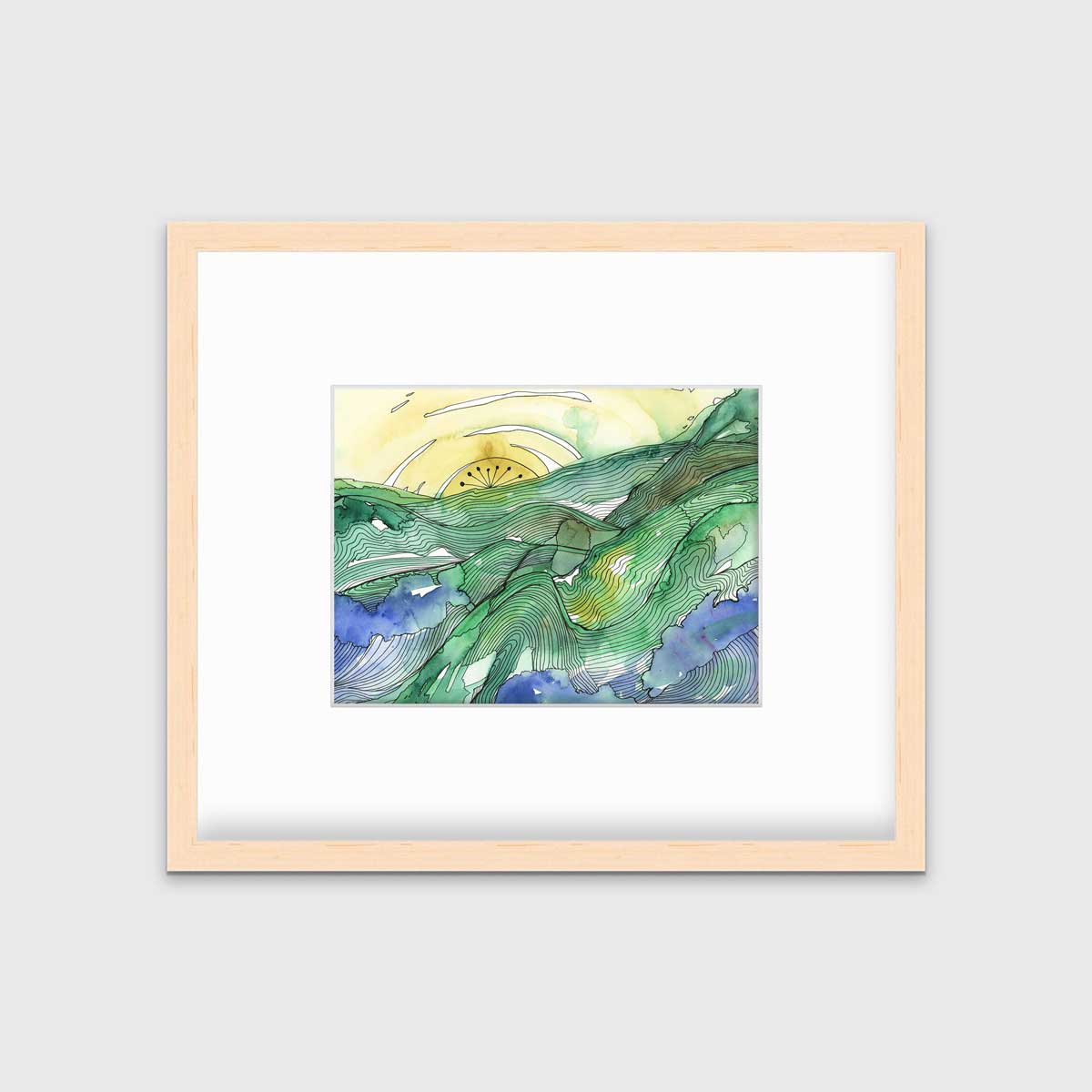 A yellow and green landscape illustration print framed in a natural wood frame with a mat hangs on a white wall.