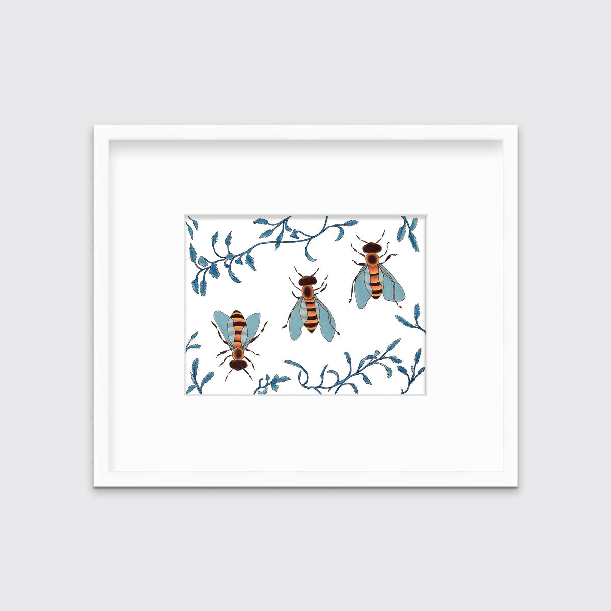 A print of three bees surrounded by blue ferns in a white frame with a mat.